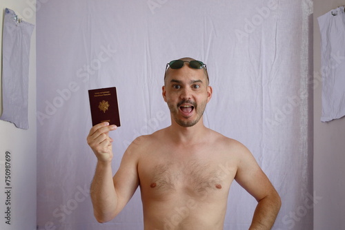 expressive baldman holding his french passport photo