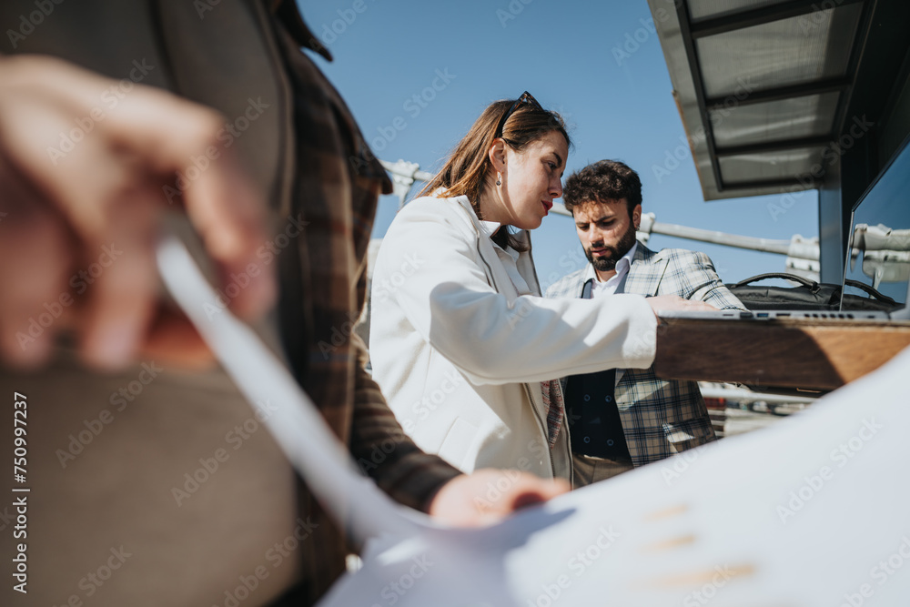 Two young business associates collaborate on a project, engaging in a strategy discussion in a downtown city environment. Two young business associates collaborate on a project, engaging in a strategy discussion in a downtown city environment.