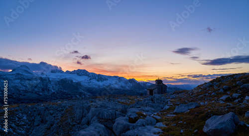 Beautiful panorama of the Dachstein Mountains with Sunset, People and Heilbronn Chapel.