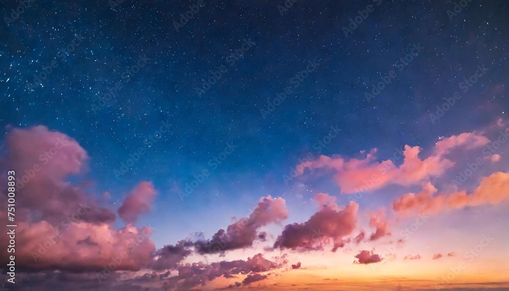 close up of twilight sky with pink clouds and stars