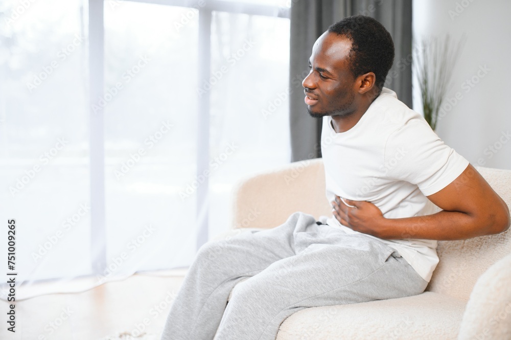 Black Man Having Stomachache Suffering From Painful Abdominal Spasm Standing Touching Aching Abdomen At Home Black Man Having Stomachache Suffering From Painful Abdominal Spasm Standing Touching Aching Abdomen At Home