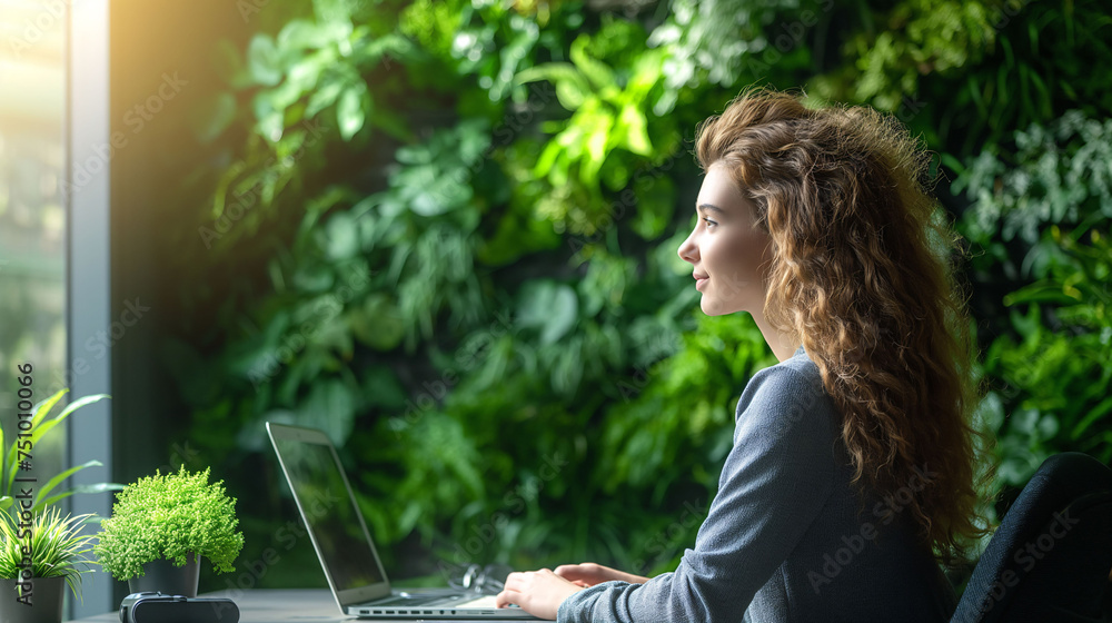Woman working in the office wit vertical garden - obrazy, fototapety, plakaty 