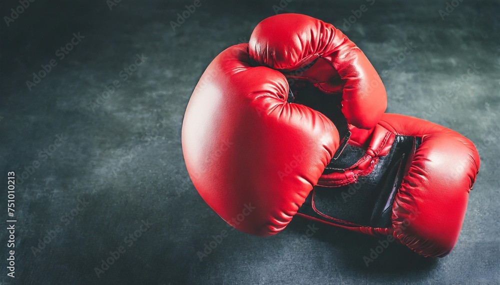 red boxing gloves punching close up on dark background