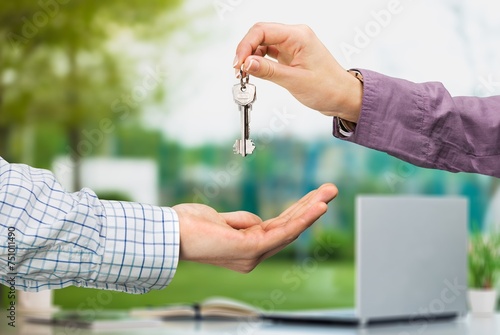 Officer gives keys from the house to client, real estate