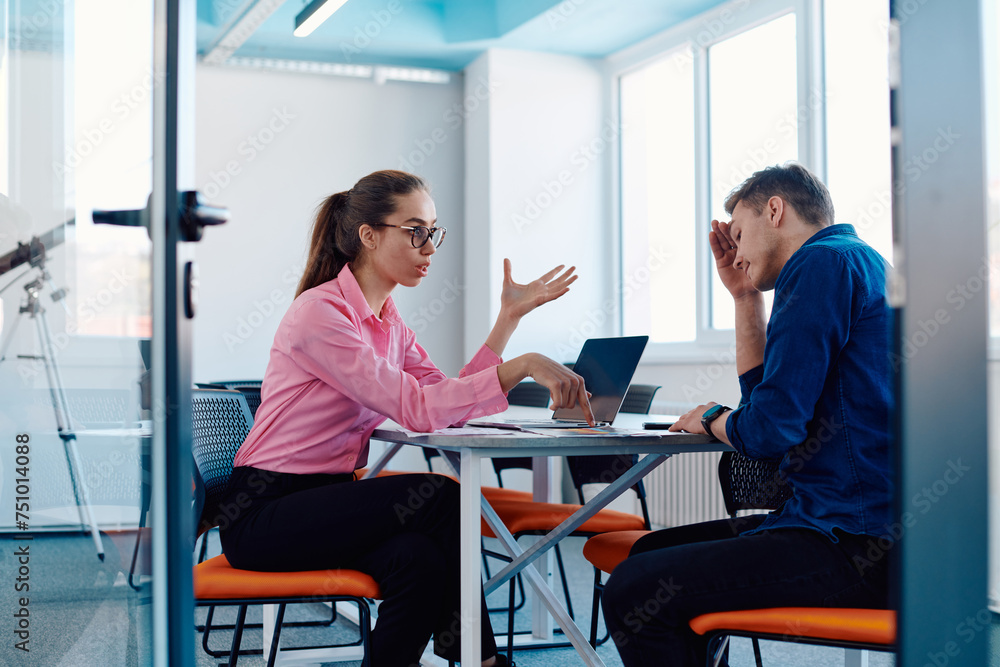 A furious business director of a startup office berating her employee for business mistakes and errors A furious business director of a startup office berating her employee for business mistakes and errors