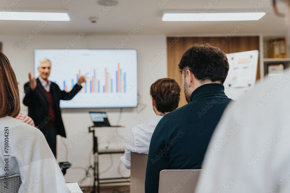 A multiethnic group of coworkers collaborating and brainstorming ideas for business success in a boardroom meeting. A multiethnic group of coworkers collaborating and brainstorming ideas for business success in a boardroom meeting.
