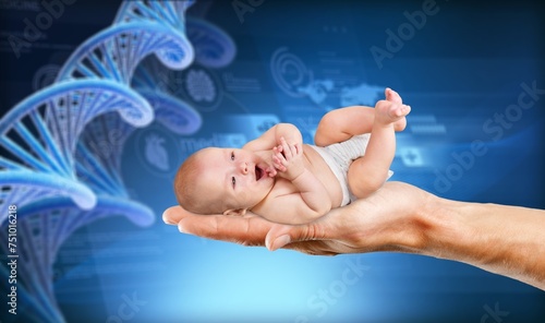 Noninvasive prenatal test. Woman holding baby on DNA structure photo