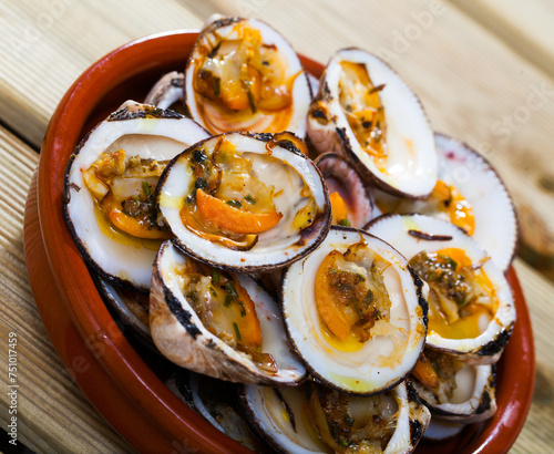 Sea food - appetizing baked in oven bivalve shellfishes (Dog cockles) served in bowl