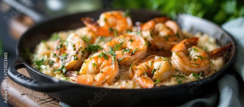 A skillet filled with sizzling shrimp and rice, showcasing succulent shrimp, creamy rice, and aromatic herbs being cooked to perfection.