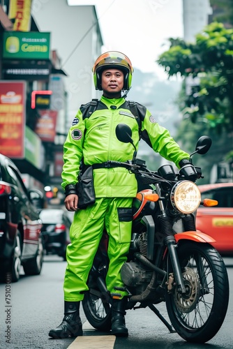 an Indonesian men working as online motorcycle taxi driver in green color safety driving clothing
