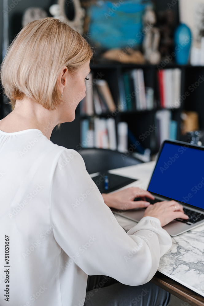 Elegant businesswoman working on laptop at home Elegant businesswoman working on laptop at home