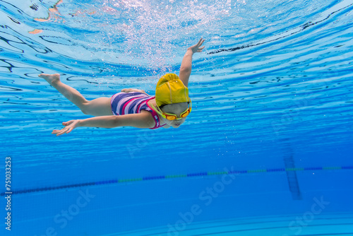 little girl swimming underwater