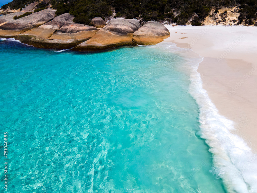 Aerial view of waves breaking on a white sand beach Aerial view of waves breaking on a white sand beach