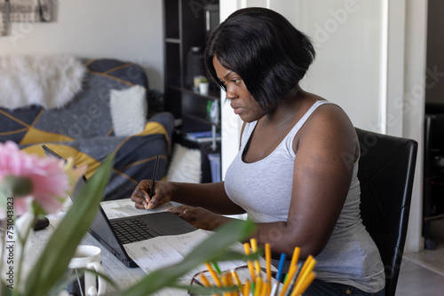 freelancer woman works on laptop computer, learn online from home photo