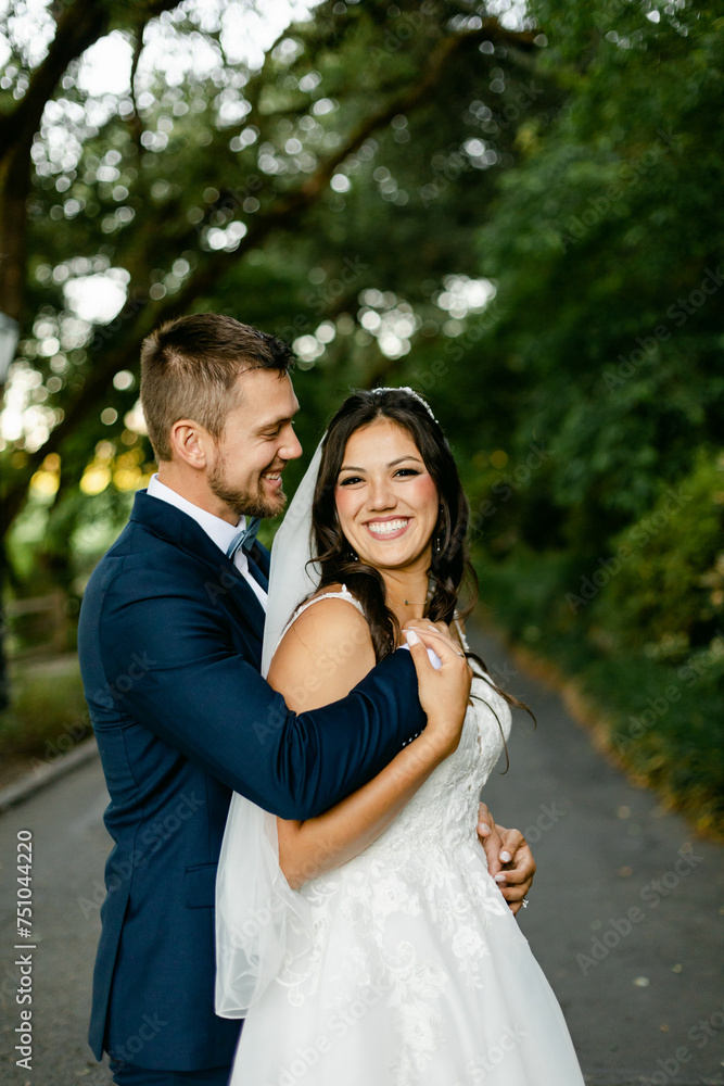 A Beaming Bride and Groom Embrace each other and Smile A Beaming Bride and Groom Embrace each other and Smile