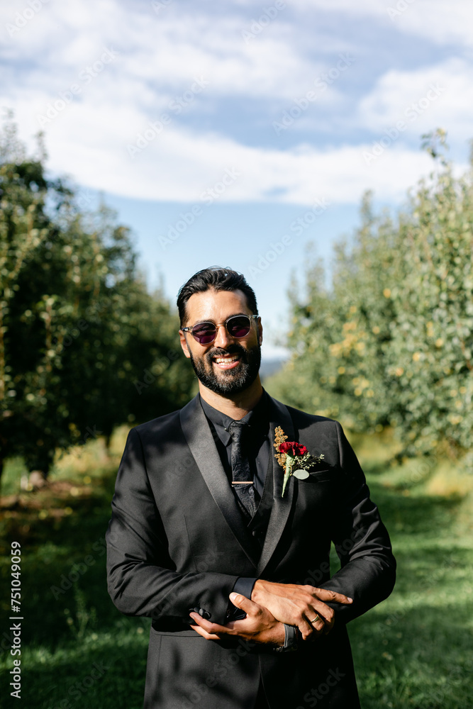 A Handsome Groom Wearing Sunglasses Smiles A Handsome Groom Wearing Sunglasses Smiles