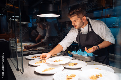 Male chef doing plating for banquet