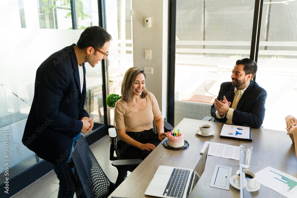 Businesspeople celebrating a birthday in a meeting room Businesspeople celebrating a birthday in a meeting room