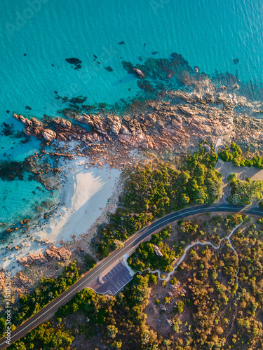 The road winding past the picturesque turquoise water at sunrise. photo