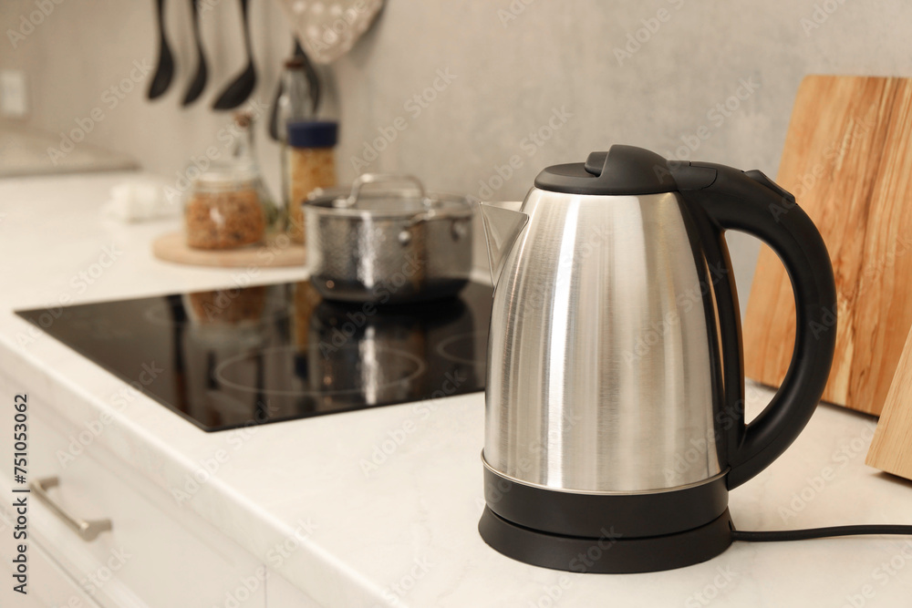 Modern electric kettle on counter in kitchen Modern electric kettle on counter in kitchen
