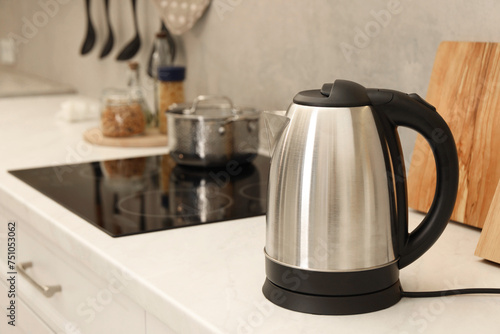 Modern electric kettle on counter in kitchen