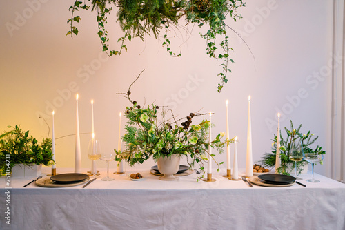 Festive Christmas table decoration arrangement with burning candles photo