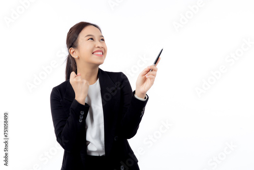 A cheerful young asian businesswoman in a suit, smiling and looking up, holding a pen, celebrating a success isolated white background, joyful business woman with pen celebrating success.