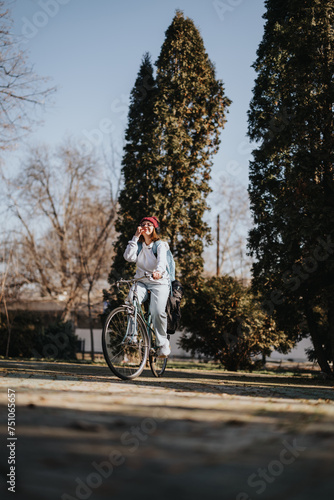 Active woman enjoying a sunny day bike ride in a park setting.