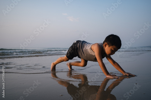 Asian boy playing on the beach photo