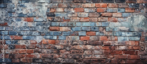 An old brick wall featuring a mix of blue and red bricks, some worn and patched, creating a rustic and weathered aesthetic. The wall has a nostalgic feel with its aged appearance.