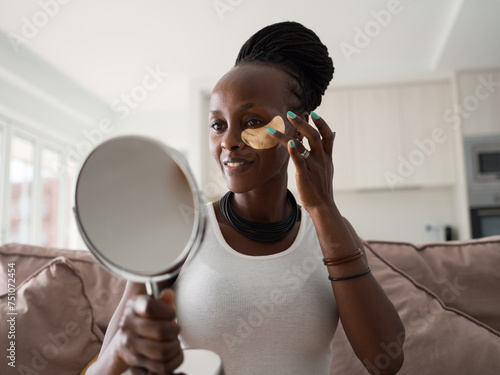 Woman with eye patch looking in mirror photo