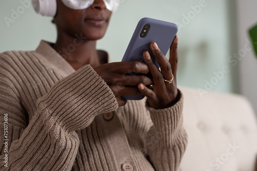 Crop woman with eye patches messaging via cellphone photo