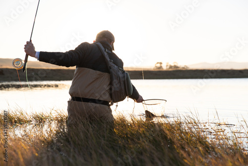 Backlit fly fisherman photo