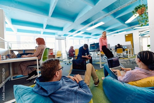 In a modern startup office, a diverse group of young and capable businesspeople engage in lively discussions about various projects, showcasing teamwork, innovation, and entrepreneurial spirit