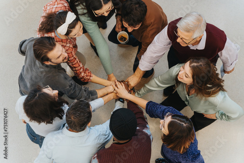 Fotografie Multiracial business group of people joining hands in a team building exercise