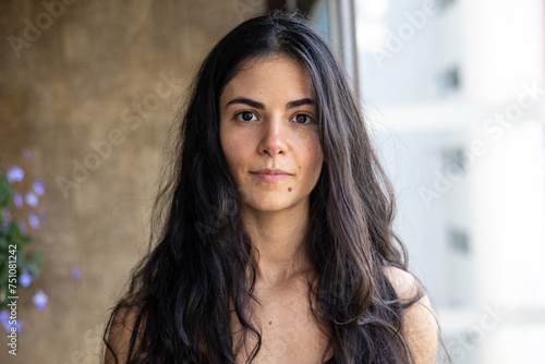 Portrait: long dark hair woman looking at the camera photo