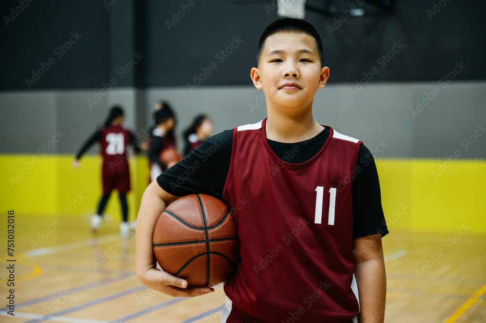 Portrait of basketball boy standing in a gym Portrait of basketball boy standing in a gym
