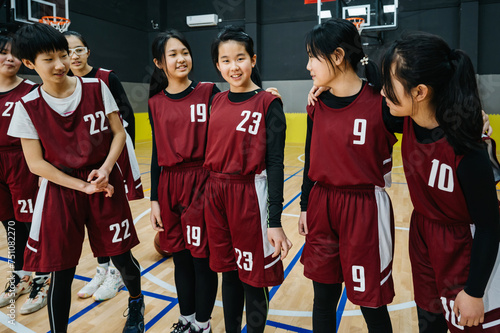 Portrait of basketball girls laughing in a gym photo