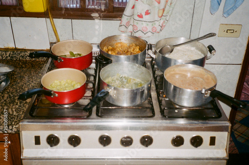 Vintage photo of pans on stove cooking complete Brazilian meal