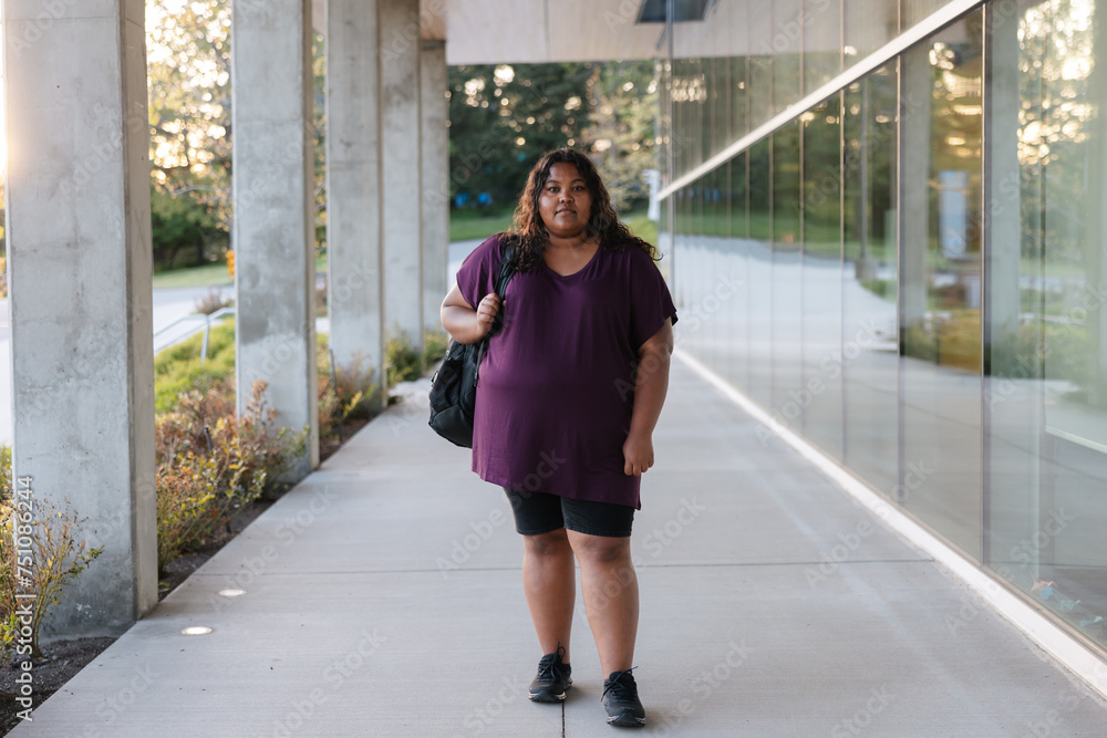 Confident portrait of young woman outside modern building. Confident portrait of young woman outside modern building.