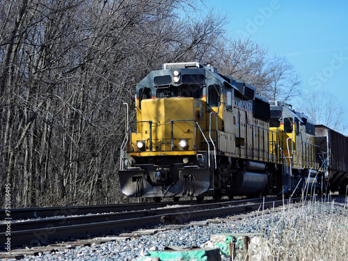 Diesel locomotive pulling a freight train of grain cars