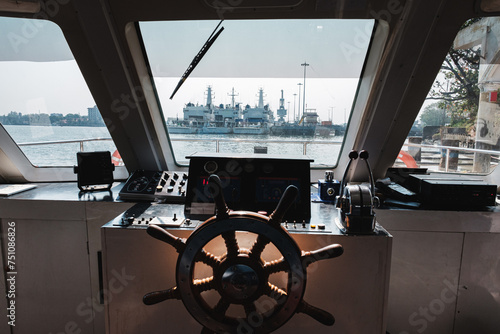 Industrial ships through the window of a ferry.  photo