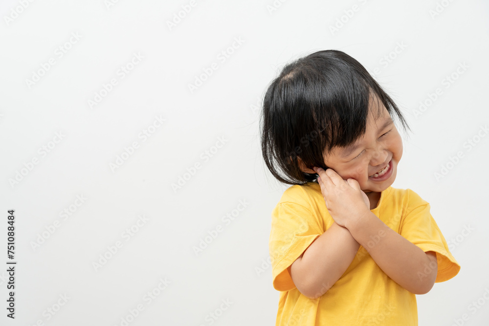 little asian girl presses hand to cheek, suffers from pain in tooth. Teeth decay, dental problems, child emotions and facial expression, oral health care, reducing sweets, fluorine coating little asian girl presses hand to cheek, suffers from pain in tooth. Teeth decay, dental problems, child emotions and facial expression, oral health care, reducing sweets, fluorine coating