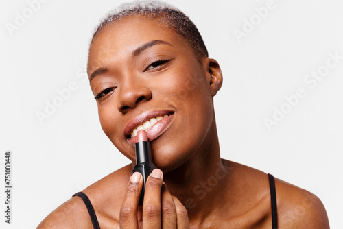 Young woman applying make-up photo