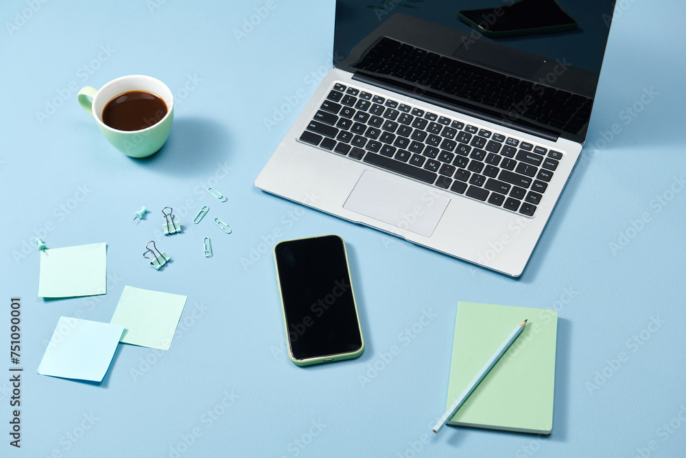 Paper and office supplies on the beige table Paper and office supplies on the beige table
