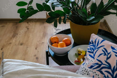 The girl is treated alone at home, there is marmalade and tangerines