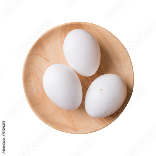 Organic white leghorn egg from free range farm on wooden plate, top view