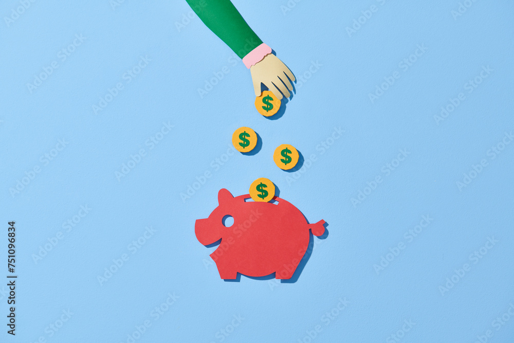 female hand puts gold coins in money box female hand puts gold coins in money box