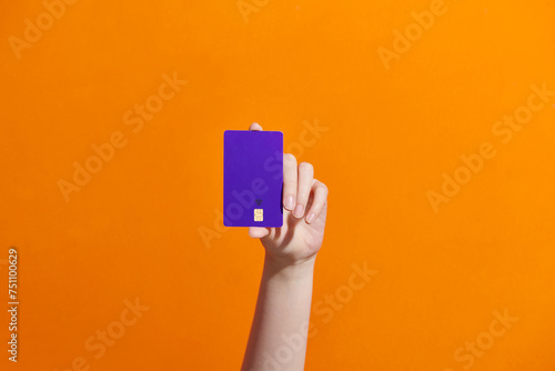 Credit card with chip in a female hand photo