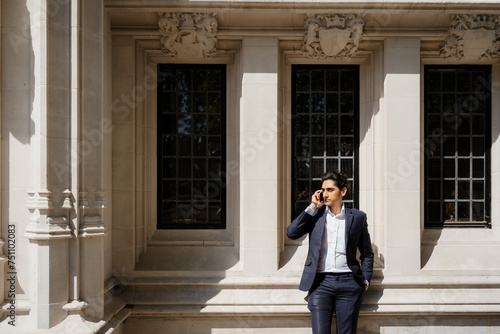 Businessman uses a smartphone in the city photo